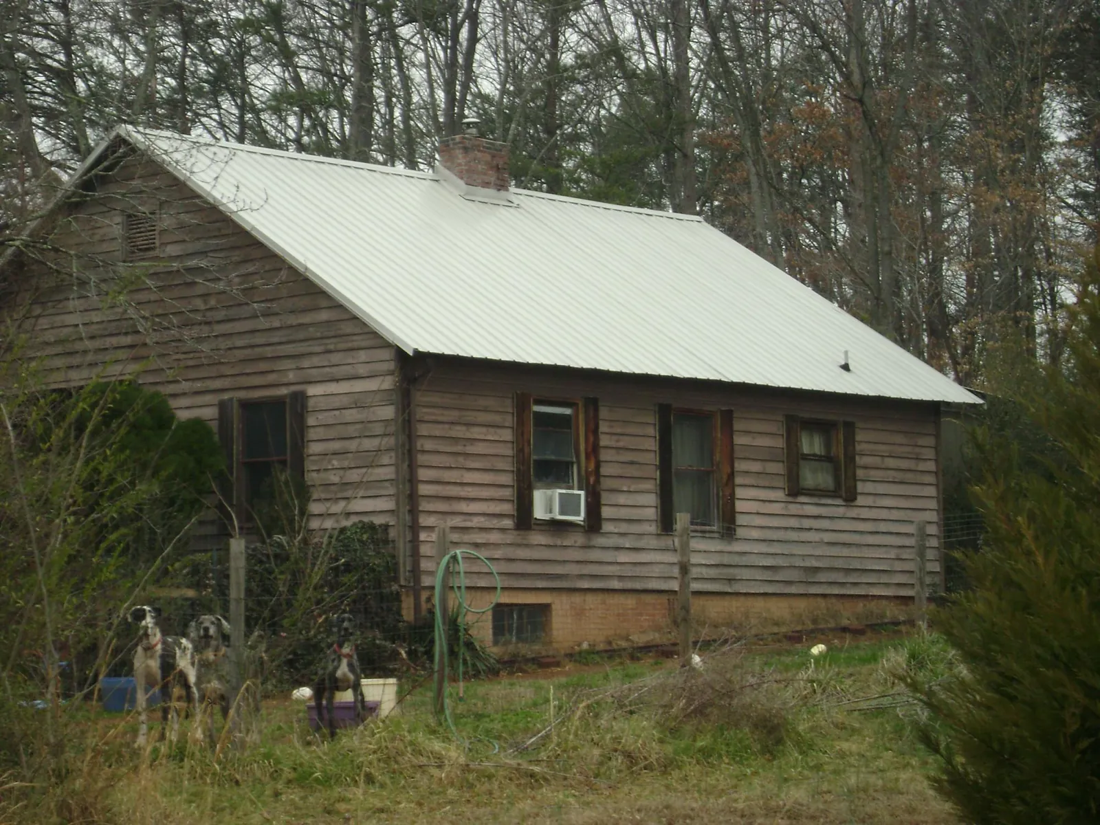 White metal roof on an old wood sided farmhouse, from a Asphalt Shingle Roof Repair job in Mechanicsburg